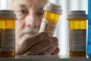 pharmaceutical negligence, man looking at prescription drugs